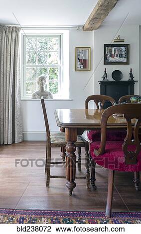 Stock Image - Bust on window near dining table. Fotosearch
