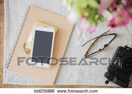 "Camera, cell phone, purse, notebook and wallet on table" View Large Photo Image Stock Photograph - "Camera, cell phone, purse, notebook and wallet on table". Fotosearch