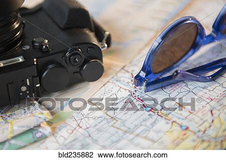 Stock Image - "Camera, sunglasses and maps". Fotosearch
