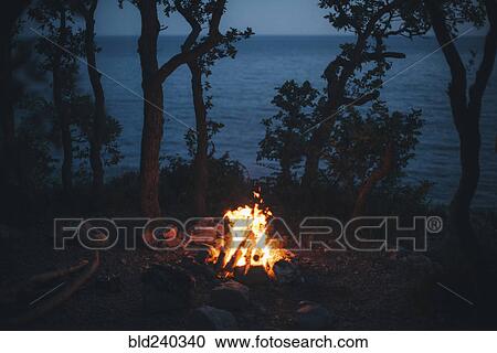 Campfire at night near ocean View Large Photo Image Stock Image - Campfire at night near ocean. Fotosearch