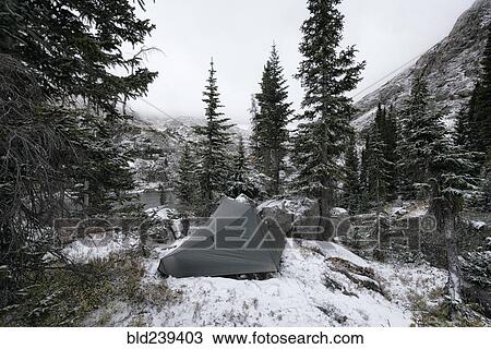 Stock Image - Camping tent in snowy landscape. Fotosearch