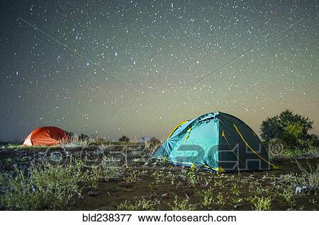 Stock Photo - Camping tents under starry sky. Fotosearch