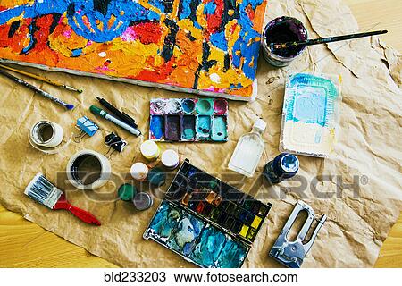 Stock Image - Canvas and painting tools on brown paper. Fotosearch