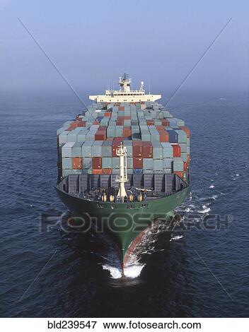 Stock Photo - Cargo containers on freighter in ocean. Fotosearch