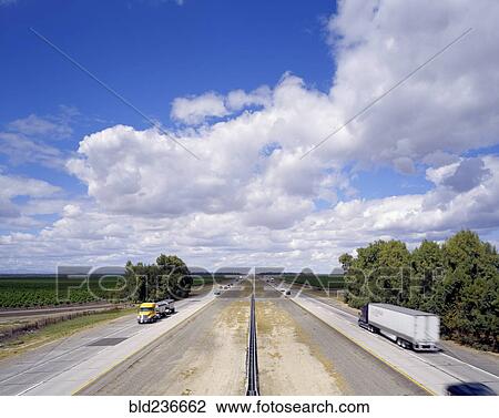 Cars and semi-trucks driving on freeway View Large Photo Image Stock Image - Cars and semi-trucks driving on freeway. Fotosearch