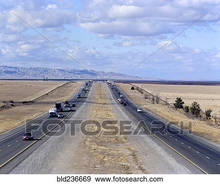 Cars and semi-trucks driving on freeway View Large Photo Image Stock Photo - Cars and semi-trucks driving on freeway. Fotosearch