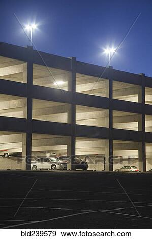 Cars in parking garage at night View Large Photo Image Stock Photo - Cars in parking garage at night. Fotosearch