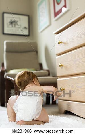 Stock Photograph - Caucasian baby boy crawling on carpet. Fotosearch