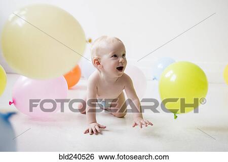 Caucasian baby boy crawling on floor watching balloons View Large Photo Image Stock Photograph - Caucasian baby boy crawling on floor watching balloons. Fotosearch