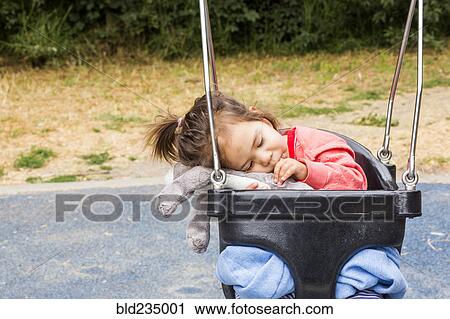 Caucasian baby girl sucking thumb in swing View Large Photo Image Stock Image - Caucasian baby girl sucking thumb in swing. Fotosearch