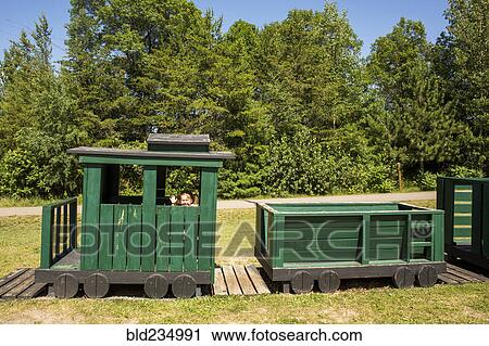Caucasian baby girl waving on playground train View Large Photo Image Stock Image - Caucasian baby girl waving on playground train. Fotosearch