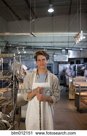 Caucasian baker standing in bakery View Large Photo Image Stock Image - Caucasian baker standing in bakery. Fotosearch