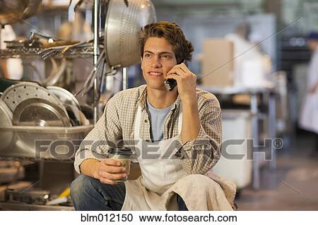 Caucasian baker talking on telephone in bakery View Large Photo Image Stock Image - Caucasian baker talking on telephone in bakery. Fotosearch