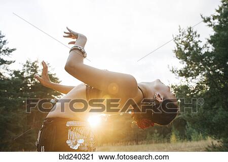 Caucasian belly dancer in field leaning backward View Large Photo Image Stock Image - Caucasian belly dancer in field leaning backward. Fotosearch