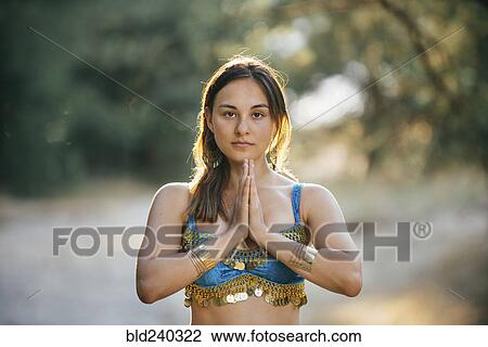 Caucasian belly dancer with hands clasped View Large Photo Image Stock Image - Caucasian belly dancer with hands clasped. Fotosearch