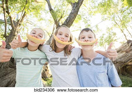 Caucasian boy and girls smiling with cantaloupe rinds View Large Photo Image Stock Photograph - Caucasian boy and girls smiling with cantaloupe rinds. Fotosearch