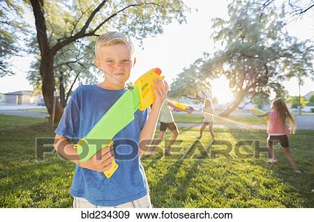 Caucasian boy posing with squirt guns View Large Photo Image Stock Photo - Caucasian boy posing with squirt guns. Fotosearch