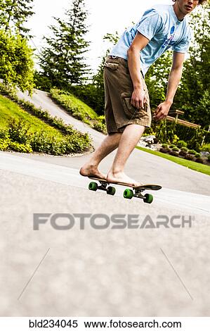Caucasian boy skateboarding barefoot View Large Photo Image Stock Photography - Caucasian boy skateboarding barefoot. Fotosearch
