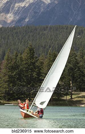 Stock Photography - Caucasian boys and girl sailing on lake. Fotosearch