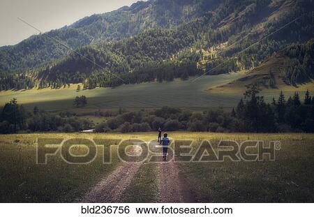 Stock Photograph - Caucasian boys walking on remote path. Fotosearch