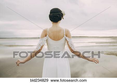 Stock Photo - Caucasian bride at beach. Fotosearch
