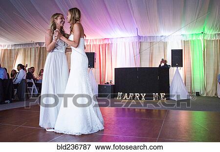 Caucasian brides dancing at wedding View Large Photo Image Stock Photo - Caucasian brides dancing at wedding. Fotosearch