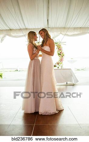 Stock Photograph - Caucasian brides dancing at wedding. Fotosearch