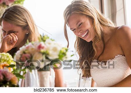Caucasian brides laughing at table View Large Photo Image Stock Photography - Caucasian brides laughing at table. Fotosearch