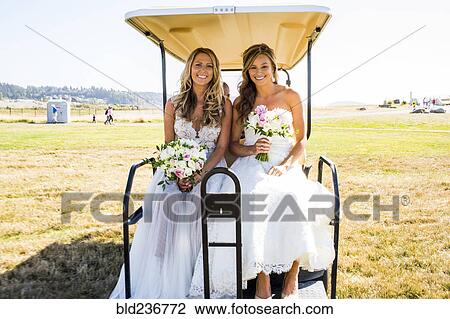 Caucasian brides sitting in golf cart View Large Photo Image Stock Image - Caucasian brides sitting in golf cart. Fotosearch