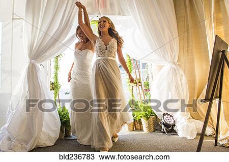 Caucasian brides walking through curtain View Large Photo Image Stock Image - Caucasian brides walking through curtain. Fotosearch