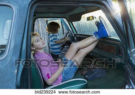 Picture - Caucasian brother and sister in truck. Fotosearch