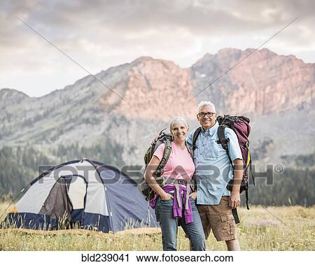 Stock Image - Caucasian couple camping on mountain. Fotosearch