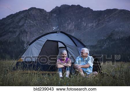 Stock Image - Caucasian couple camping on mountain. Fotosearch