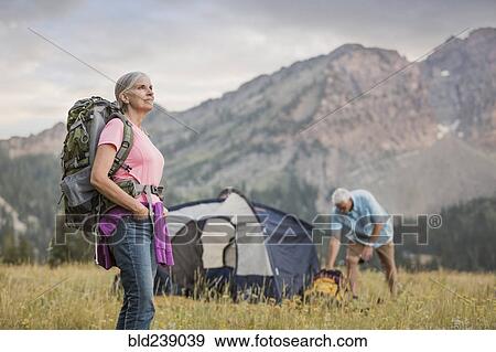 Caucasian couple camping on mountain View Large Photo Image Stock Photo - Caucasian couple camping on mountain. Fotosearch