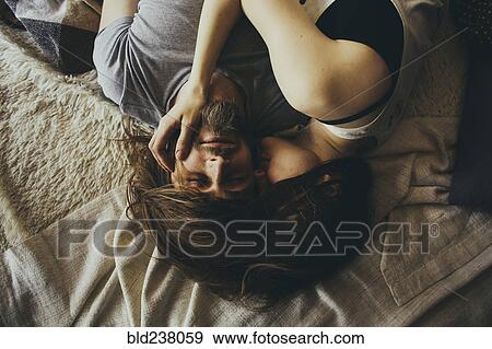 Caucasian couple cuddling with hair intertwined View Large Photo Image Stock Photo - Caucasian couple cuddling with hair intertwined. Fotosearch
