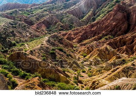 Stock Photo - Caucasian couple hiking in rocky landscape. Fotosearch