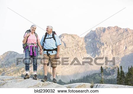 Caucasian couple hiking on mountain View Large Photo Image Stock Image - Caucasian couple hiking on mountain. Fotosearch