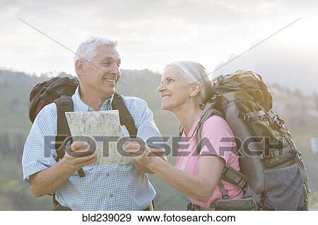 Caucasian couple hiking with map on mountain View Large Photo Image Stock Photo - Caucasian couple hiking with map on mountain. Fotosearch