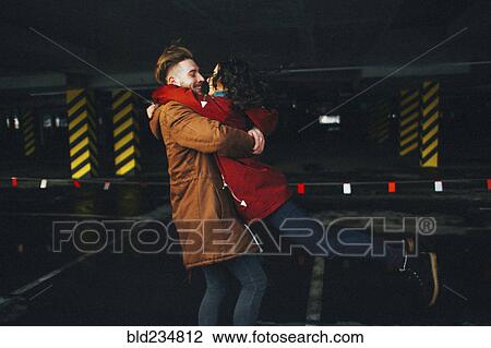Caucasian couple hugging in parking garage View Large Photo Image Stock Image - Caucasian couple hugging in parking garage. Fotosearch