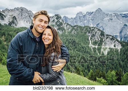 "Caucasian couple hugging neat mountain range, Tarvisio, Vienna, Austria" View Large Photo Image Stock Photo - "Caucasian couple hugging neat mountain range, Tarvisio, Vienna, Austria". Fotosearch