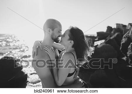 Caucasian couple hugging on sunny beach View Large Photo Image Stock Image - Caucasian couple hugging on sunny beach. Fotosearch
