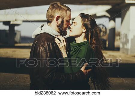 Caucasian couple hugging woman outdoors View Large Photo Image Stock Image - Caucasian couple hugging woman outdoors. Fotosearch