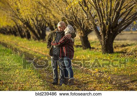 Caucasian couple kissing near trees in autumn View Large Photo Image Stock Photograph - Caucasian couple kissing near trees in autumn. Fotosearch