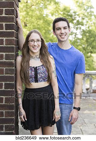 Caucasian couple leaning on wall at park View Large Photo Image Stock Photo - Caucasian couple leaning on wall at park. Fotosearch