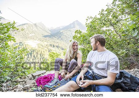 Picture - Caucasian couple preparing for rock climbing. Fotosearch