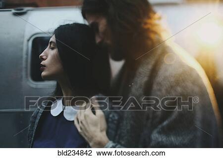 Stock Image - Caucasian couple relaxing outdoors. Fotosearch