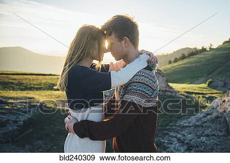 Stock Photo - Caucasian couple rubbing noses and hugging. Fotosearch