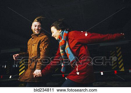 Caucasian couple running in wind View Large Photo Image Stock Image - Caucasian couple running in wind. Fotosearch