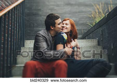Caucasian couple sitting on staircase and kissing View Large Photo Image Stock Photo - Caucasian couple sitting on staircase and kissing. Fotosearch
