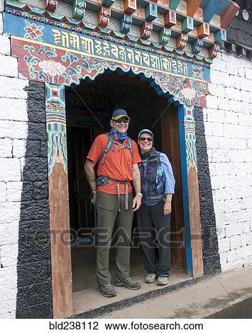 Stock Image - Caucasian couple standing in ornate doorway. Fotosearch